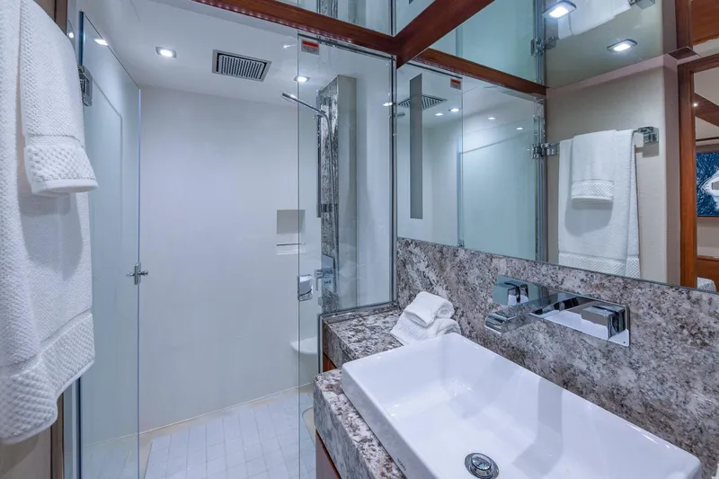  Yacht Photos Pics Luxurious bathroom in 2019 Regency P65 yacht with modern fixtures and elegant design.