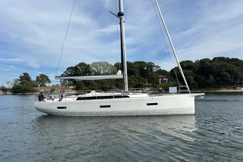 Katara Yacht Photos Pics 2023 X-Yachts X4³ MkII sailboat on calm water, surrounded by trees.