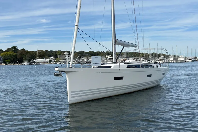 Katara Yacht Photos Pics 2023 X-Yachts X4³ MkII sailboat on calm water, marina background.