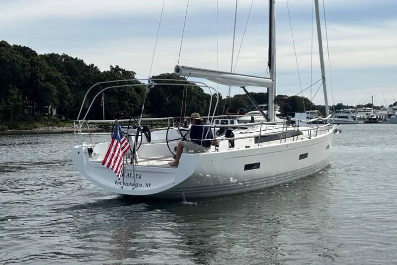 Katara Yacht Photos Pics 2023 X-Yachts X4³ MkII sailing in a calm harbor, displaying an American flag.