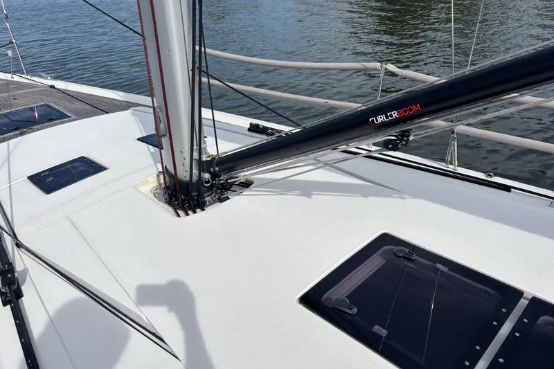 Katara Yacht Photos Pics 2023 X-Yachts X4³ MkII sailboat deck with Furler Boom, sleek design, and water backdrop.