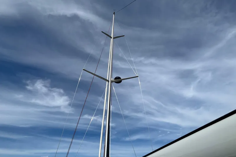 Katara Yacht Photos Pics Mast of 2023 X-Yachts X4³ MkII against a cloudy sky.