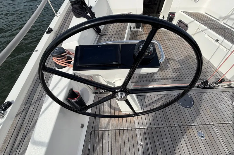 Katara Yacht Photos Pics Steering wheel of 2023 X-Yachts X4³ MkII sailboat on teak deck.