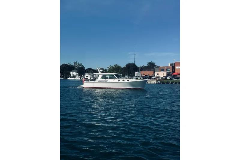 2021 Back Cove 37 Yacht Photos Pics 2021 Back Cove 37 boat cruising on a sunny day near a waterfront town.