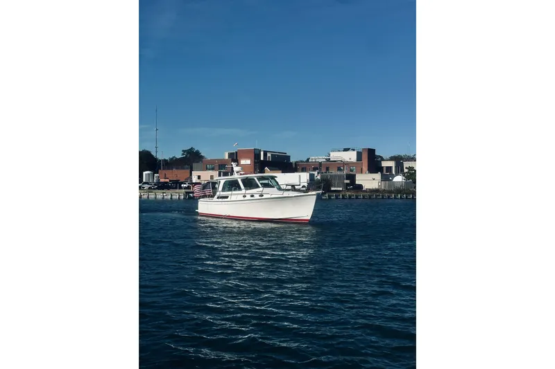 2021 Back Cove 37 Yacht Photos Pics 2021 Back Cove 37 boat on water near urban waterfront buildings.