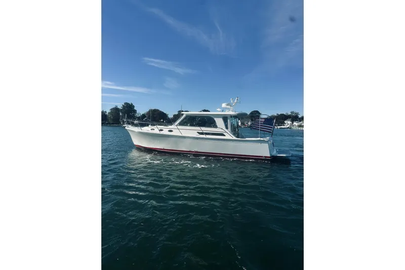 2021 Back Cove 37 Yacht Photos Pics 2021 Back Cove 37 boat cruising on a sunny day with an American flag.