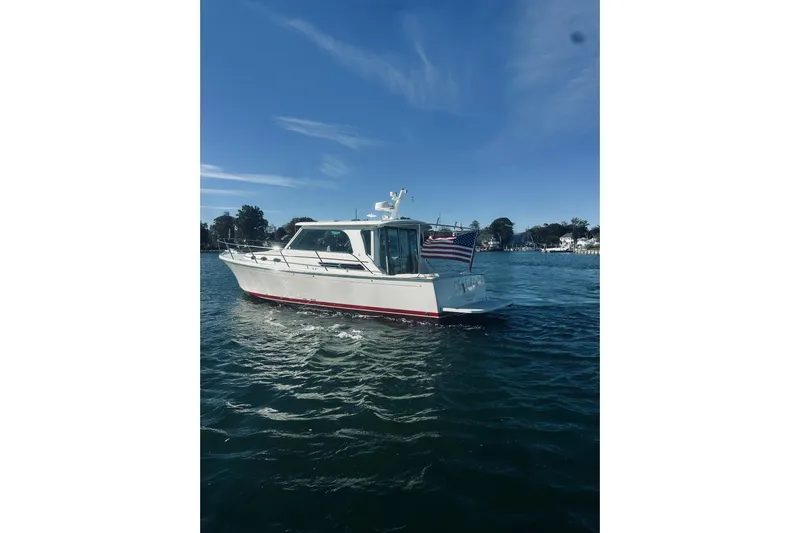 2021 Back Cove 37 Yacht Photos Pics 2021 Back Cove 37 boat on water with American flag, clear sky background.
