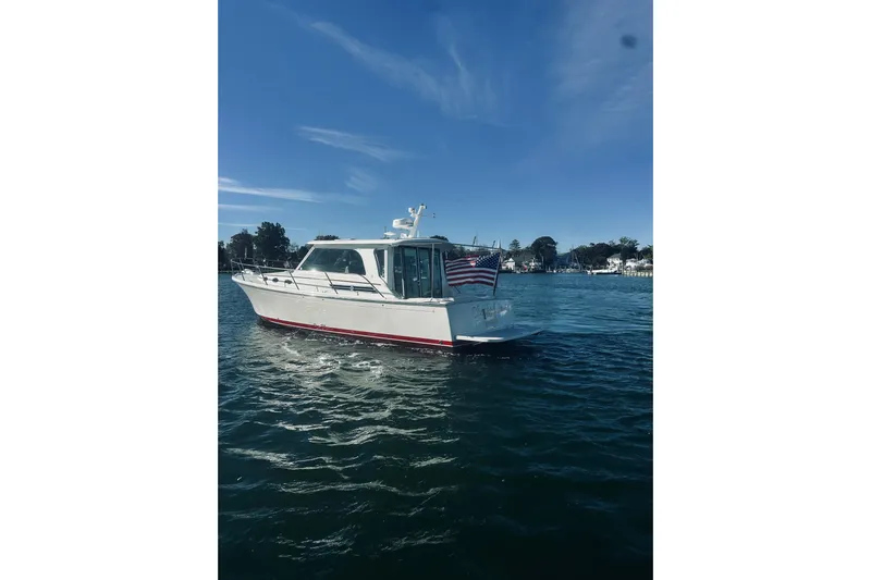 2021 Back Cove 37 Yacht Photos Pics 2021 Back Cove 37 boat on water with American flag, clear sky background.