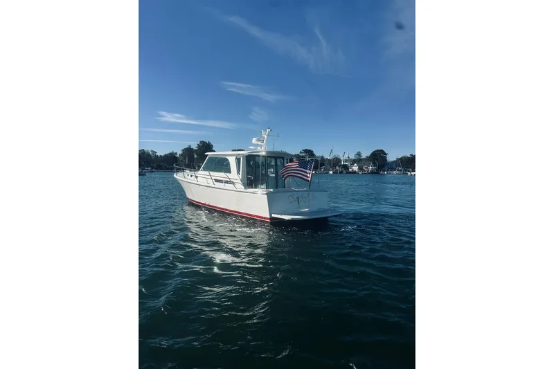 2021 Back Cove 37 Yacht Photos Pics 2021 Back Cove 37 boat on water with American flag, clear sky background.