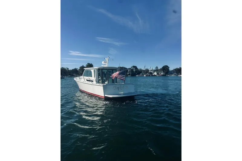 2021 Back Cove 37 Yacht Photos Pics 2021 Back Cove 37 boat on water with American flag, clear sky background.