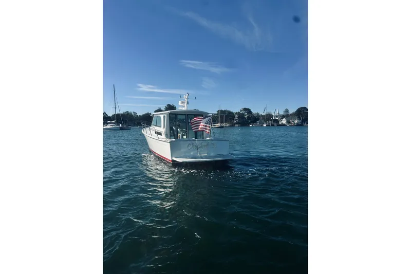 2021 Back Cove 37 Yacht Photos Pics 2021 Back Cove 37 boat on calm water with American flag, clear sky background.