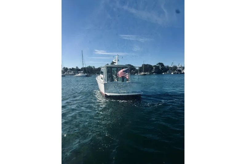 2021 Back Cove 37 Yacht Photos Pics 2021 Back Cove 37 boat on calm water with American flag, clear sky background.