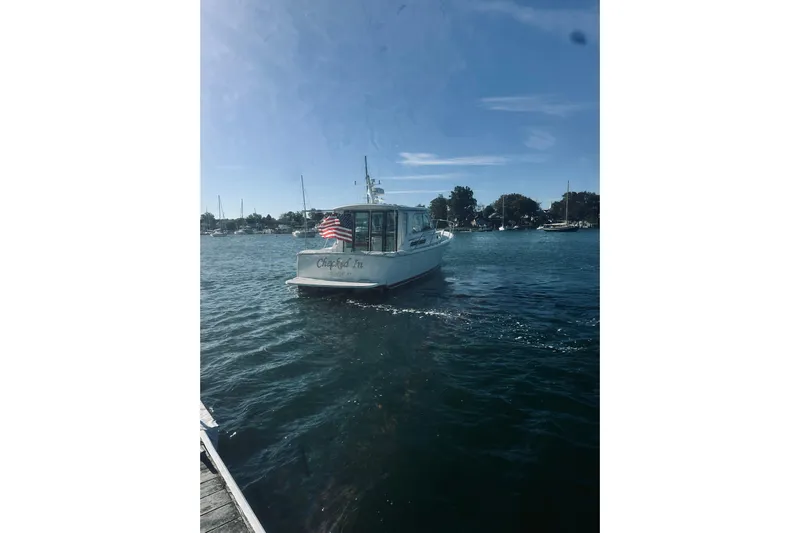 2021 Back Cove 37 Yacht Photos Pics 2021 Back Cove 37 boat on water with American flag, clear sky background.