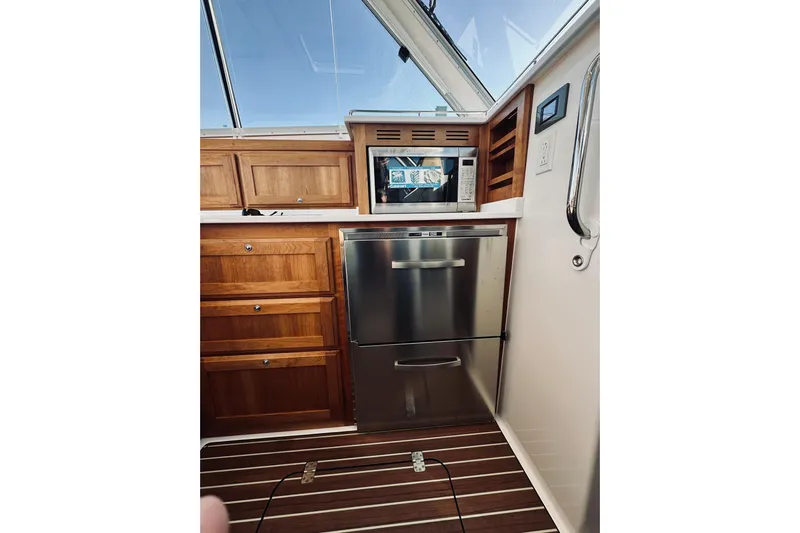 2021 Back Cove 37 Yacht Photos Pics 2021 Back Cove 37 yacht interior with wooden cabinetry, stainless steel appliances, and modern design.