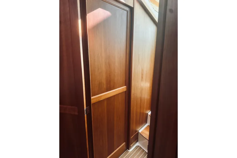 2021 Back Cove 37 Yacht Photos Pics Interior view of 2021 Back Cove 37 yacht, featuring wooden paneling and steps.