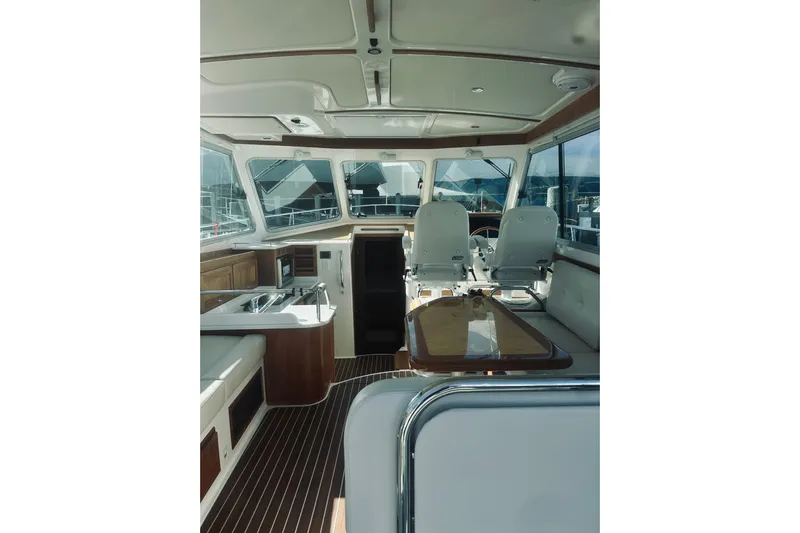 2021 Back Cove 37 Yacht Photos Pics Interior of 2021 Back Cove 37 yacht with elegant seating and wooden accents.