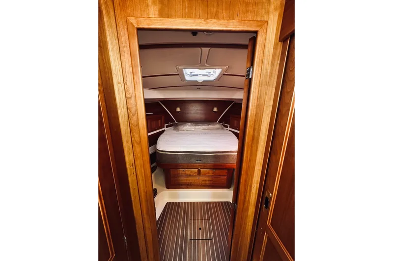 2021 Back Cove 37 Yacht Photos Pics Cozy cabin interior of 2021 Back Cove 37 yacht with wooden finish and bed.