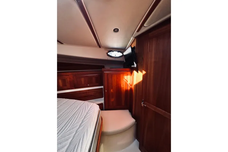 2021 Back Cove 37 Yacht Photos Pics 2021 Back Cove 37 interior cabin with wood paneling and bed.