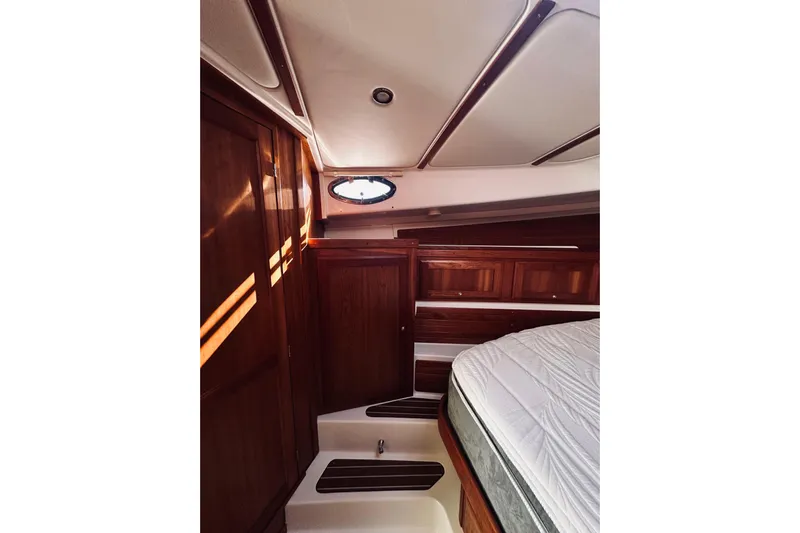 2021 Back Cove 37 Yacht Photos Pics 2021 Back Cove 37 yacht interior with wood paneling and bed.