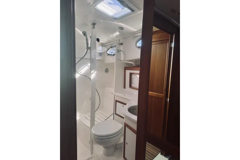 2021 Back Cove 37 Yacht Photos Pics Luxurious bathroom in 2021 Back Cove 37 yacht with shower and wooden cabinetry.