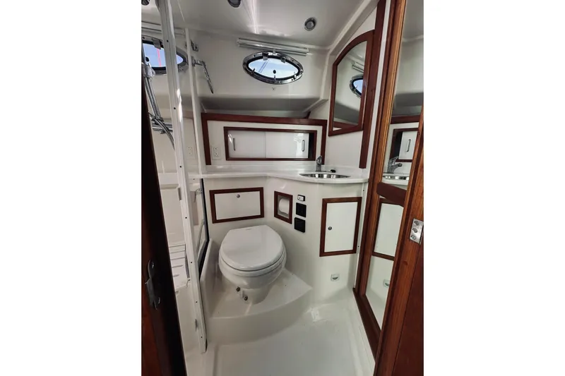 2021 Back Cove 37 Yacht Photos Pics 2021 Back Cove 37 yacht bathroom with modern fixtures and wood accents.