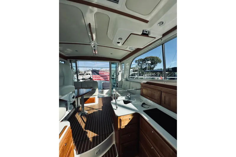 2021 Back Cove 37 Yacht Photos Pics Interior of 2021 Back Cove 37 yacht with elegant wood finish and American flag view.