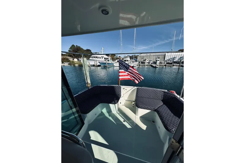 2021 Back Cove 37 Yacht Photos Pics 2021 Back Cove 37 boat with American flag, docked in a marina under clear skies.