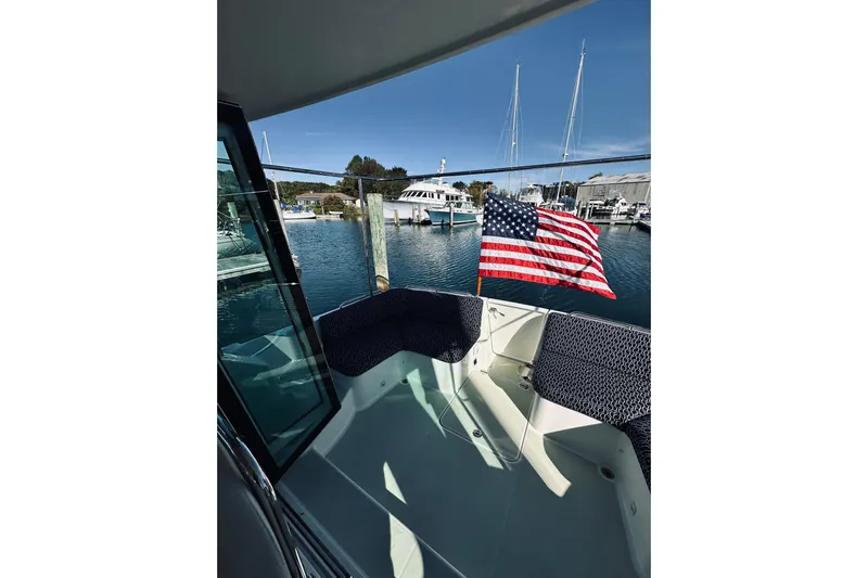 2021 Back Cove 37 Yacht Photos Pics Back Cove 37 (2021) boat deck with American flag, docked at marina.