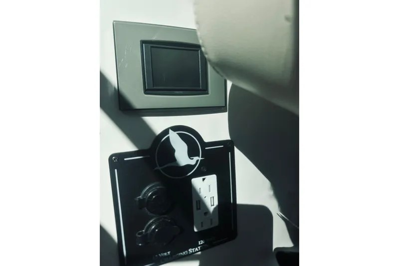 2021 Back Cove 37 Yacht Photos Pics Control panel on a 2021 Back Cove 37 boat, featuring outlets and switches.