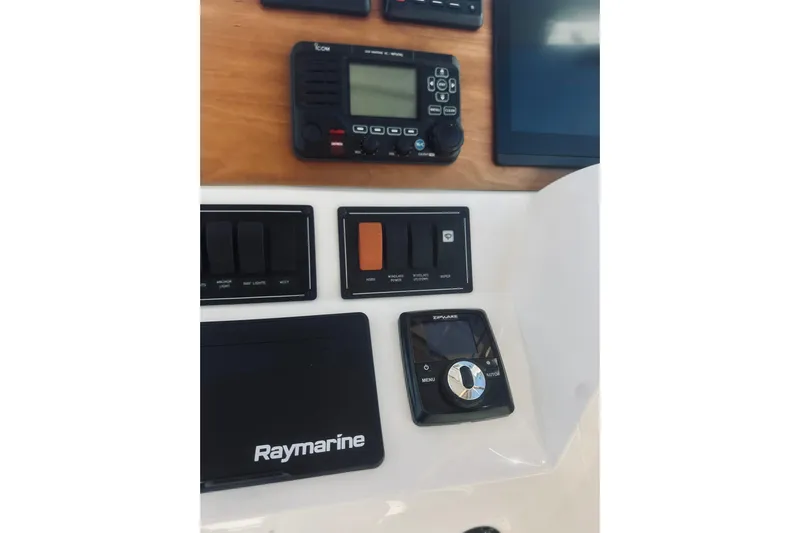 2021 Back Cove 37 Yacht Photos Pics Control panel of a 2021 Back Cove 37 boat featuring Raymarine and Icom equipment.