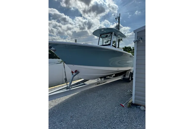  Yacht Photos Pics 2025 Sea Hunt Gamefish 27 Coffin Box boat on trailer, parked outdoors under cloudy sky.