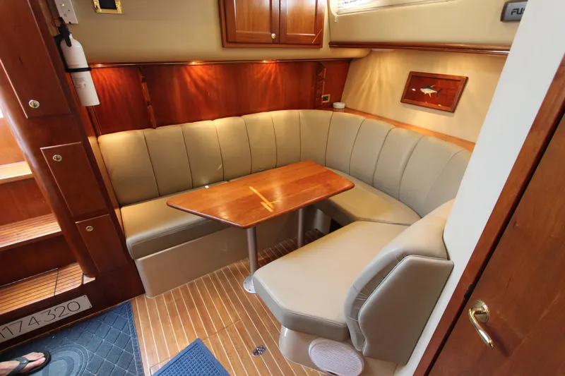 Duke Yacht Photos Pics Luxurious 2005 Rampage 35 Express yacht interior with elegant seating and wooden table.