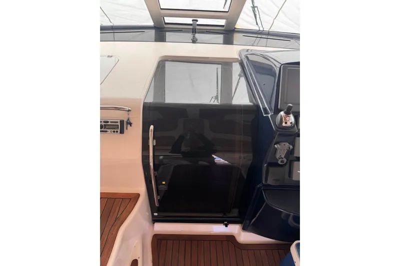  Yacht Photos Pics 2008 Tiara Sovran 43 yacht interior with sleek control panel and wooden flooring.