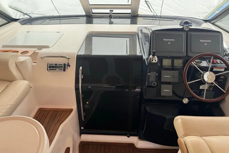  Yacht Photos Pics 2008 Tiara Sovran 43 yacht helm with Raymarine electronics and leather seating.