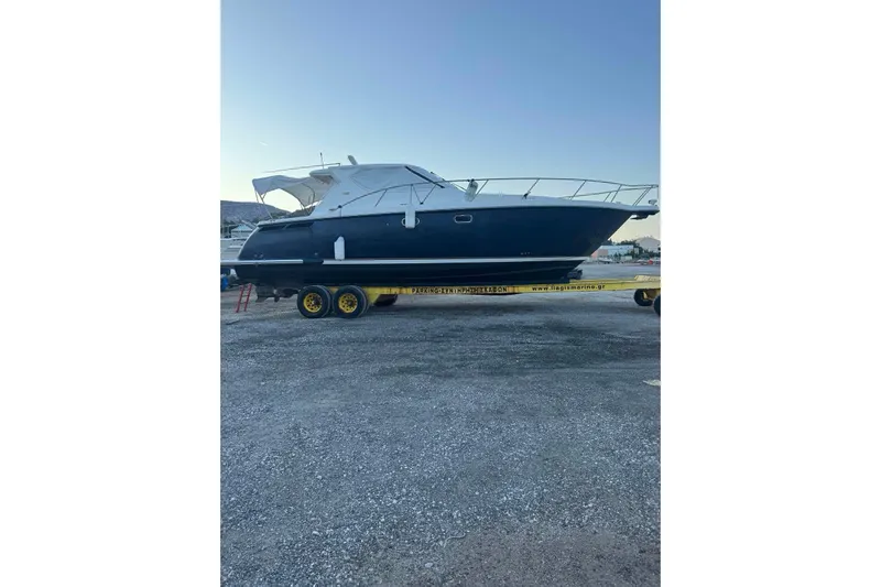  Yacht Photos Pics 2008 Tiara Sovran 43 yacht on trailer, parked outdoors under clear sky.