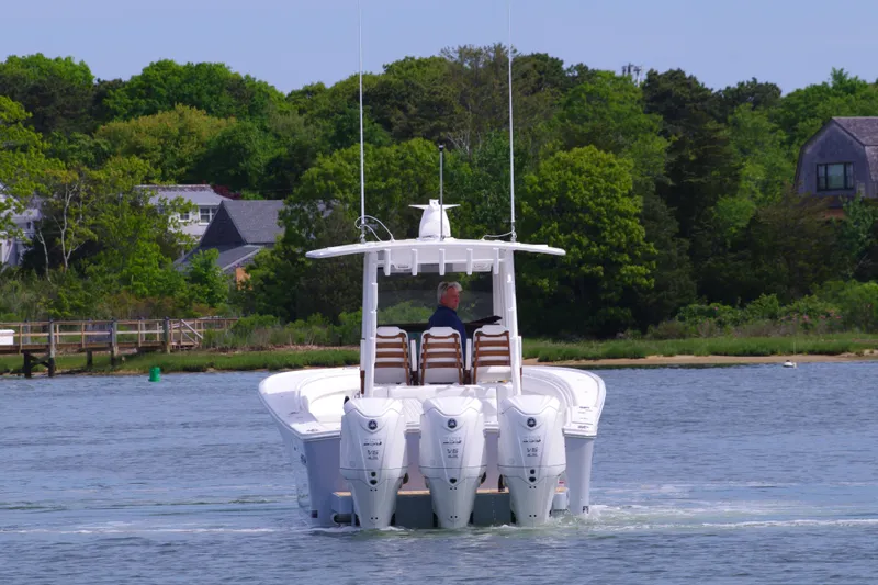 Storm Gray Yacht Photos Pics 2025 Regulator 35 boat with four engines cruising on a scenic lake.