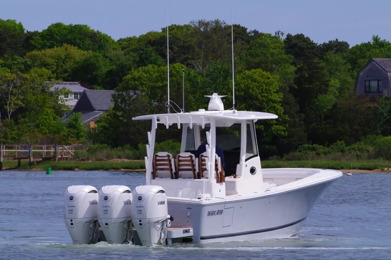 Storm Gray Yacht Photos Pics 2025 Regulator 35 boat with triple engines on a calm lake.