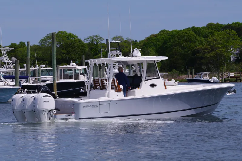 Storm Gray Yacht Photos Pics 2025 Regulator 35 boat with dual engines cruising in a marina.