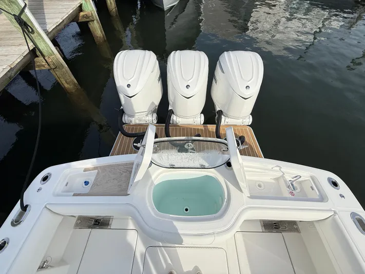 Storm Gray Yacht Photos Pics 2025 Regulator 35 boat with triple outboard engines docked at marina.