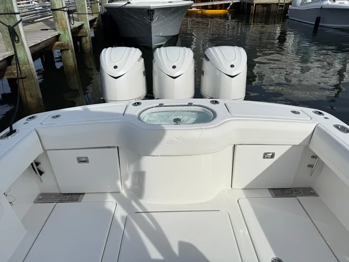 Storm Gray Yacht Photos Pics 2025 Regulator 35 boat with triple engines docked at marina.