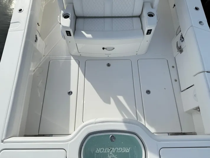 Storm Gray Yacht Photos Pics 2025 Regulator 35 boat interior with white seating and storage compartments.