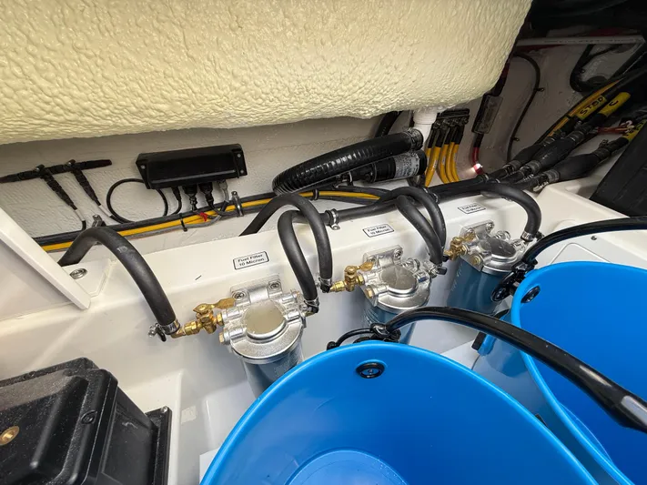 Storm Gray Yacht Photos Pics 2025 Regulator 35 boat engine compartment with fuel filters and blue buckets.
