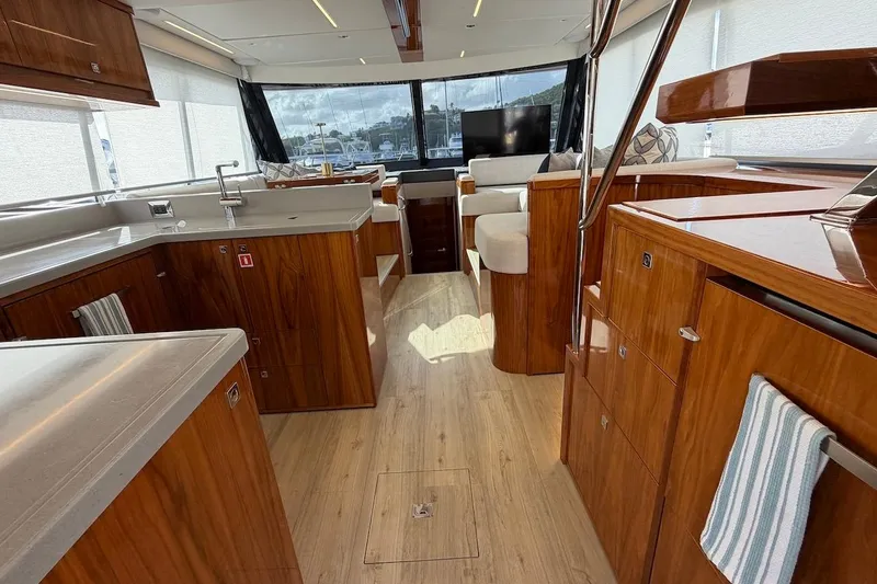  Yacht Photos Pics Luxurious interior of 2021 Riviera 50 Sports Motor Yacht with elegant wood finishes.