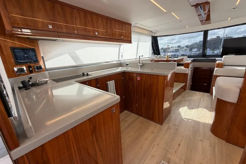  Yacht Photos Pics Luxurious interior of 2021 Riviera 50 Sports Motor Yacht with modern kitchen design.