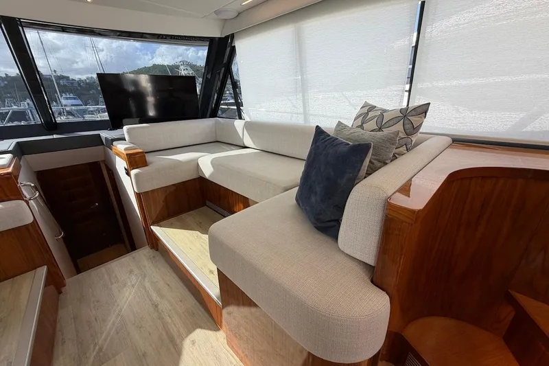  Yacht Photos Pics Luxurious interior of 2021 Riviera 50 Sports Motor Yacht with plush seating and cushions.