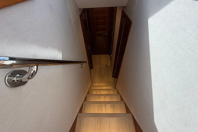  Yacht Photos Pics Staircase inside 2021 Riviera 50 Sports Motor Yacht with sleek handrail design.