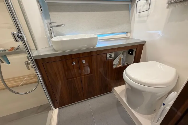  Yacht Photos Pics Luxurious bathroom in 2021 Riviera 50 Sports Motor Yacht with modern fixtures.