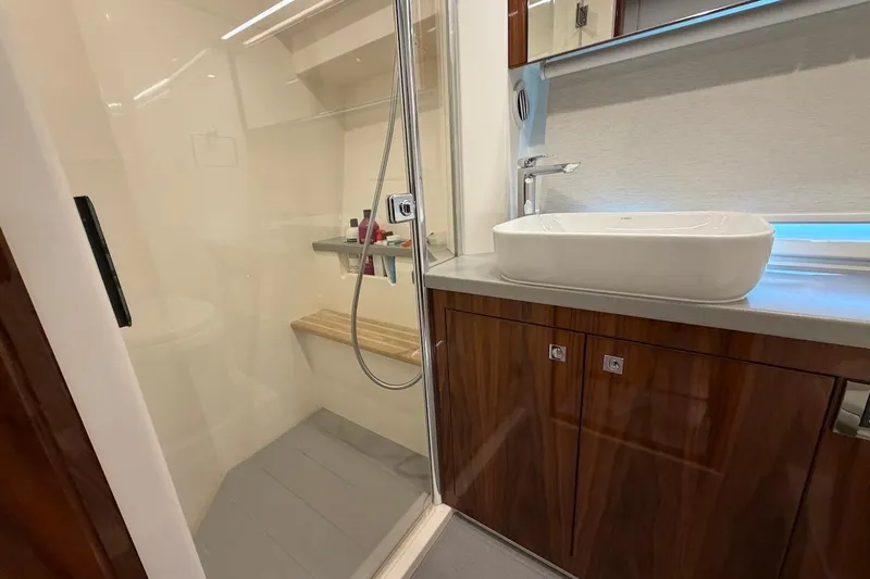  Yacht Photos Pics Luxurious bathroom in 2021 Riviera 50 Sports Motor Yacht with modern fixtures and elegant design.