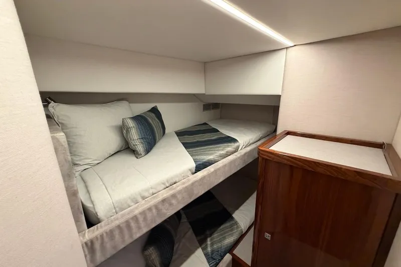  Yacht Photos Pics 2021 Riviera 50 Sports Motor Yacht cabin with cozy bunk beds and modern design.