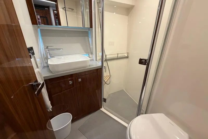 Yacht Photos Pics Luxurious bathroom in 2021 Riviera 50 Sports Motor Yacht with modern fixtures and elegant design.